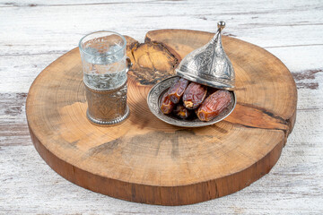 Ramadan concept: Dates, zam zam water on a wooden table