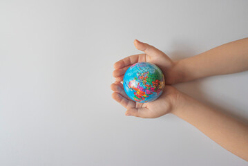 boy holding globe, globe in palm.Earth and energy concept.
empty space for text.top view.