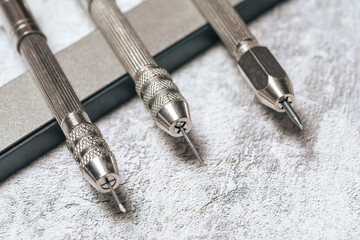 Set of sharp scrapers on diamond whetstones for sharpening. Mechanical cleaning of coins and archaeological items.