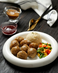 Swedish Meatballs with Creamy Gravy, Buttery Mashed Potatoes, and Lingonberry Sauce.