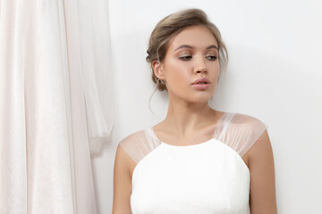 Portraits of a pretty girl with makeup and hair on a white background 