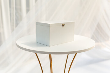 White box, a piggy bank with the initials of the bride and groom at the wedding