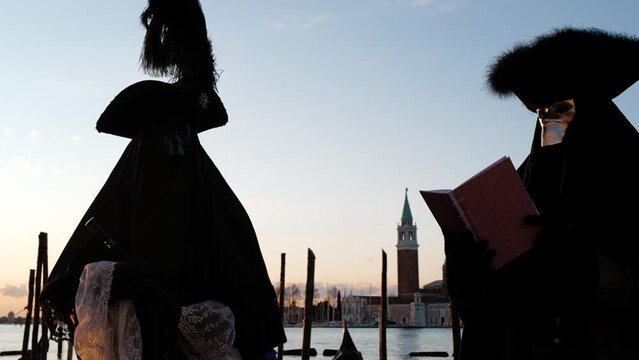 Venice, Italy - February 2022 - carnival masks are photographed with tourists in San Marco square
