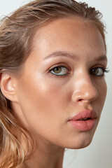 Fototapeta premium Portraits of a pretty girl with makeup and hair on a white background 