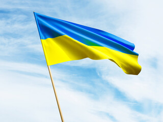 Ukraine waving flag isolated on the blue sky