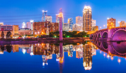 Fototapeta na wymiar Minneapolis skyline with reflection in river at night.