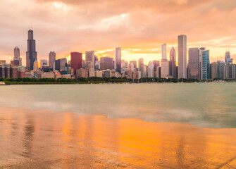 chicago,illinois,usa. 8-11-17: Chicago skyline at sunset with cloudy sky and reflection in water.