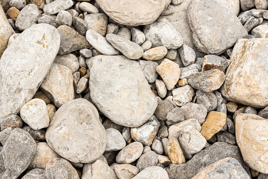 Backdrop of different size gray pebbles on beach