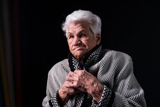 Portrait Of Serious Senior Woman Against Black Background