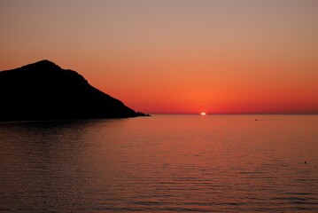 Naklejka na ściany i meble Beautiful sunset at beach of Galeria. Corsica, France.