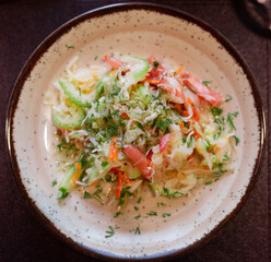 Fresh vegetable salad with tomatoes, cucumbers and celery on plate