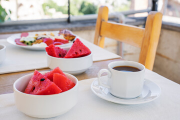 Summer morning breakfast or brunch on the terrace with watermelon slices.
