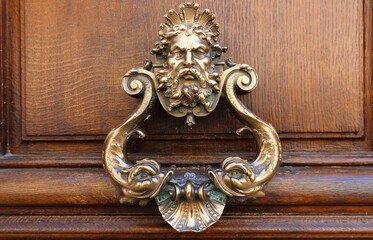 European Vintage old metal wrought iron door knocker. Design detail. Paris.