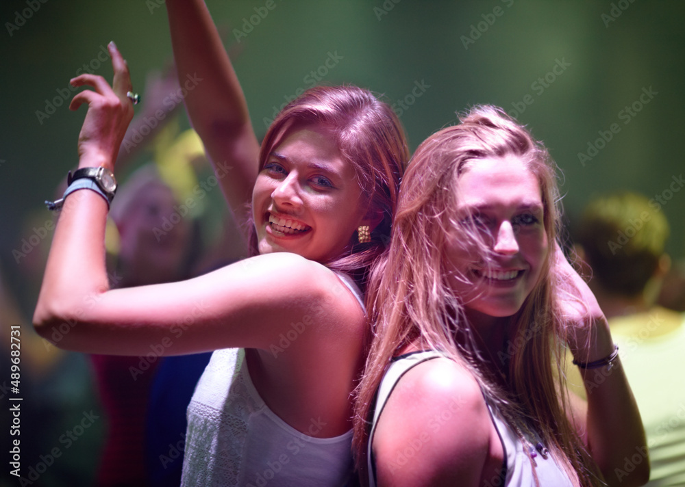 Wall mural letting loose at the club. a pretty young woman partying it up with friends in the club.