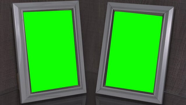 Two blank wooden photo frames with green chroma key space stands on glass shelf at home