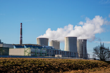 Dukovany Nuclear Power Plant in the Czech Republic, Europe. Smoke cooling towers. There are clouds in the sky. In the background the nature of the Highlands.