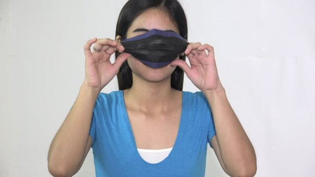 Female Asian Teenager Wearing Facemask Wrong