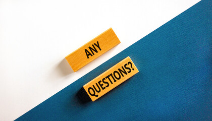 Any questions symbol. Concept words Any questions on wooden blocks on a beautiful blue table white...
