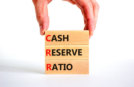 CRR cash reserve ratio symbol. Concept words CRR cash reserve ratio on blocks on a beautiful white table, white background. Businessman hand. Business and CRR cash reserve ratio concept. Copy space.