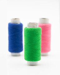 group of colorful yarn or spool thread over on yellow background like rainbow