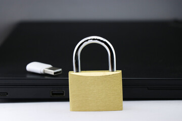 Data privacy protection concept is shown using metal lock and storage device with a computer on...