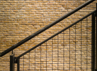 a black stairs in front of a brick wall in Bangkok, Thailand