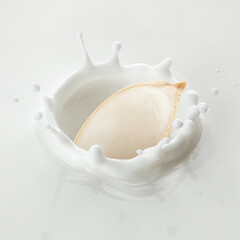 Pumpkin seed falls into milk, yoghurt, sour cream, Splash