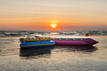 Banana boat on the beach with sunset background in Thailand.