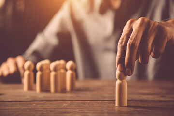 Hand choose person wooden doll concept of leadership and business team creative thinking and human resources for teamwork or team player.