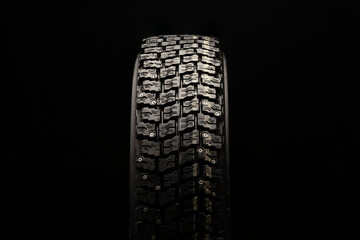 new winter studded tire on a black background