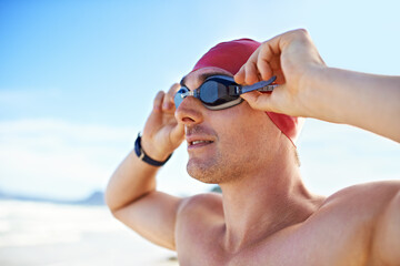 Goggles on. Cropped closeup shot of a man wearing swimming goggles looking out at the ocean.