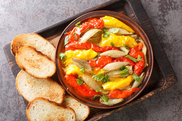 Escalivada Catalana or escalibada is a Spanish roasted vegetable dish closeup in the wooden board on the table. Horizontal top view from above