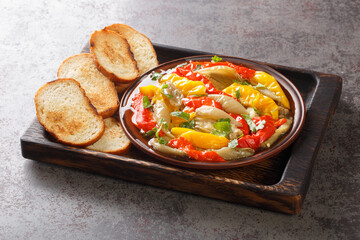 Escalivada Smoky Slow Roasted Vegetables pepper, eggplant, onion closeup in the wooden board on the table. Horizontal