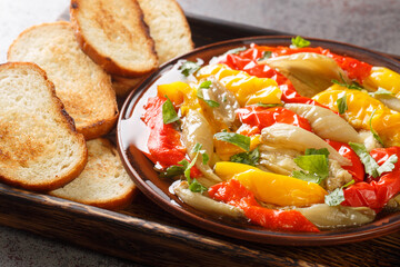 Escalivada Catalana or escalibada is a Spanish roasted vegetable dish closeup in the wooden board on the table. Horizontal
