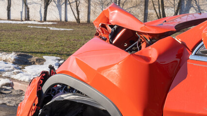 Orange car crash background. Close-up detail of auto wreck. Front side of crashed car from...