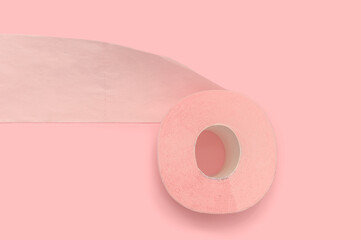 Pink toilet paper on a pink background. Health and hygiene every day.