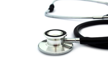 On a white isolated background lies a black stethoscope.