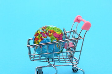 The layout of the earth is in a miniature shopping cart.