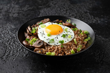 Bowl of Buckwheat with mushrooms, onion and egg. Healthy food