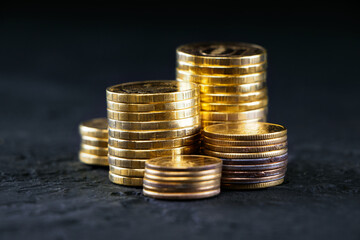 A stack of gold coins isolated on a black background.Money on a black background.Finance and money