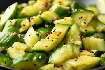Smashed cucumber spicy Asian style salad with soy sauce dressing, chilli flakes, garlic and sesame seeds