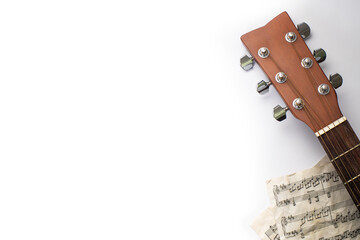 Closeup of guitar headstock with dummy musical score in white background, Banner, Overhead with...