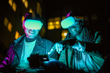 two men explore metaverse via headsets and augmented reality, using a technological device as a...