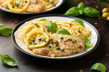Chicken Piccata with capers, white wine sauce and spaghetti. Italian food