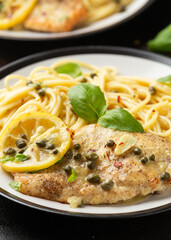 Chicken Piccata with capers, white wine sauce and spaghetti. Italian food