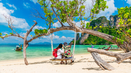 Couple traveler relaxing on swing joy nature view scenic landscape Phakbia beach Krabi, Attraction...