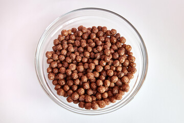 Granola in a transparent bowl on a white background. Healthy food.
