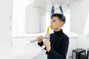 A seven-year-old boy had a computed tomography of the jaw, a circular image of the jaw in modern dentistry. Prevention of caries, prosthetics and dental treatment. Radiology, panoramic scanner.