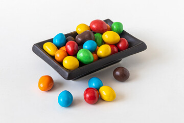 Fototapeta na wymiar Multicolored round candies in a rectangular plate
