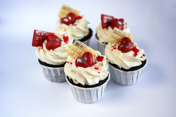 chocolate cupcakes with cream cheese frosting and festive decor. Valentine's day or birthday dessert. Beautiful festive food for a wedding or children's party.